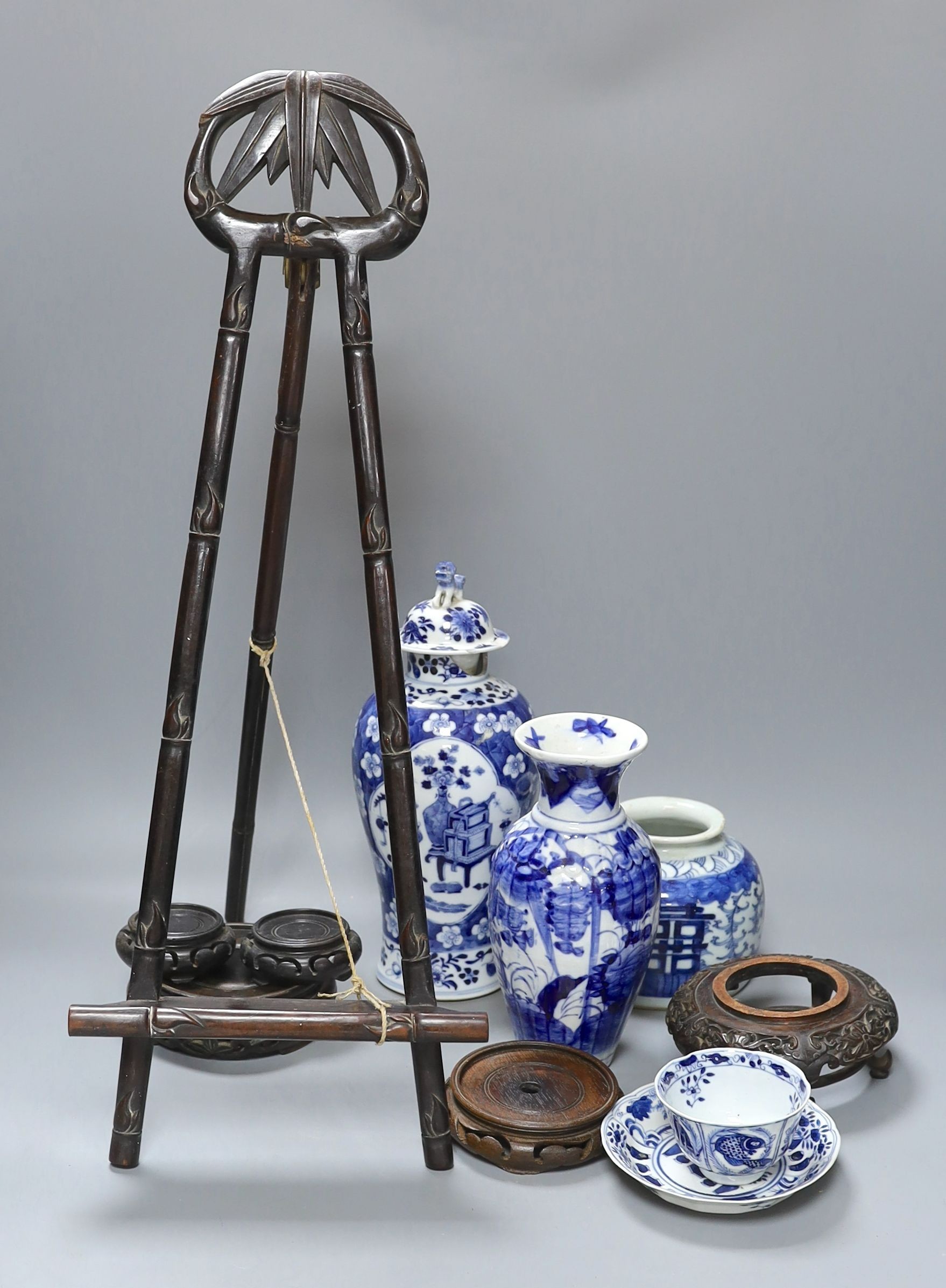 A Chinese Kangxi style blue and white teabowl and saucer, other oriental ceramics, carved hardwood easel, etc.